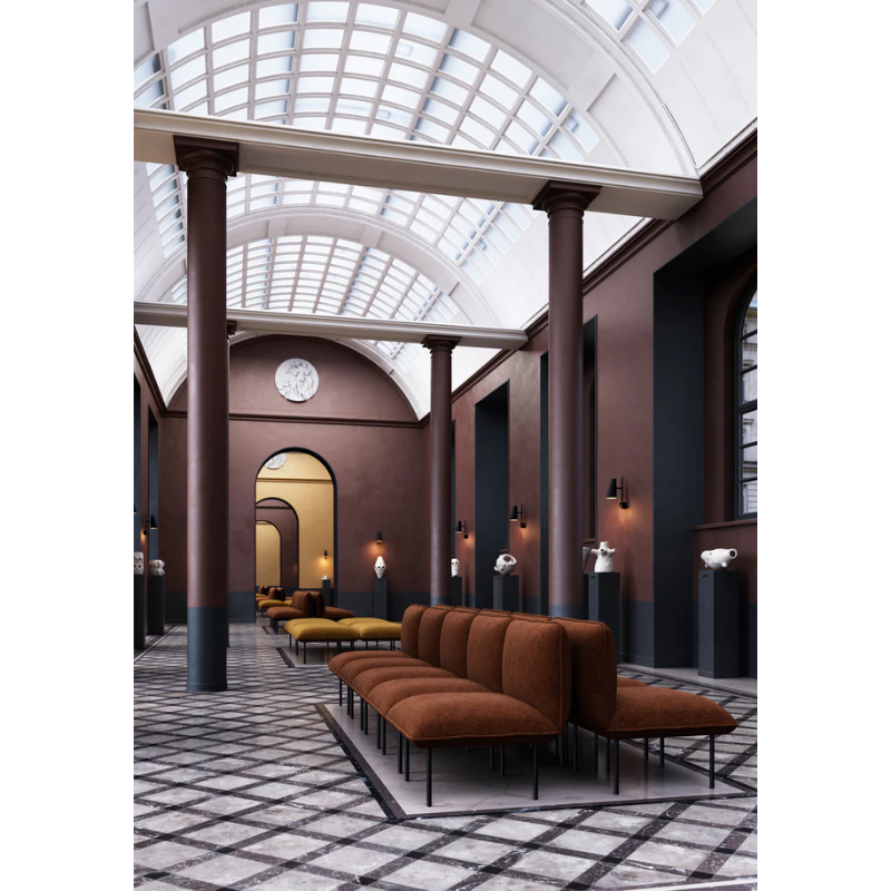 The Nakki Lobby Ottoman from Woud with a custom fabric in a hotel.