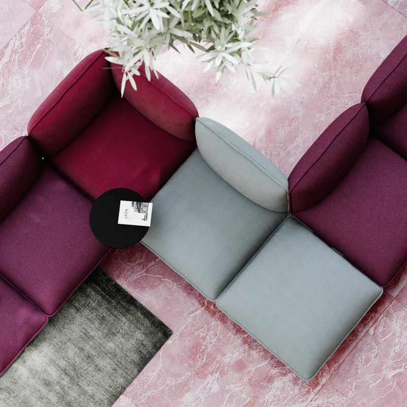 The Nakki Lobby Ottoman from Woud with a custom fabric in a business.