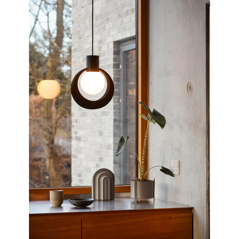The small Pidestall Planter on a kitchen counter under a light next to the Akriv Bookend.