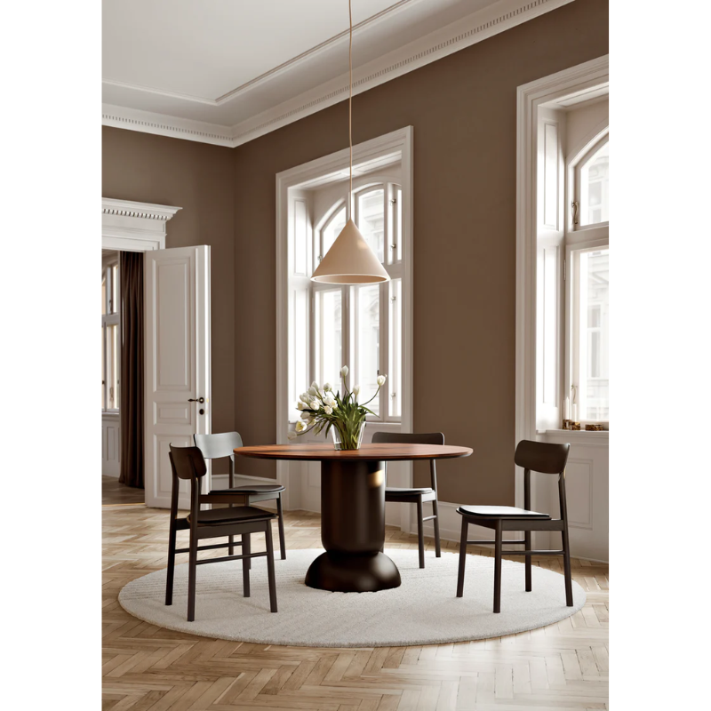 The Soma Dining Chair from Woud in Black with Leather set up in a group of four around a dining table.