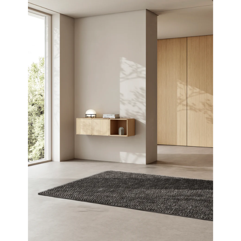 A Tact Rug from Woud in a bedroom.