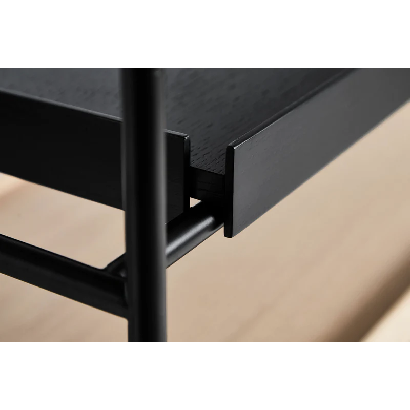 A close up on the corner and tray of the Tray Shelf from Woud.