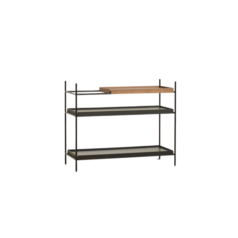 The Tray Shelf (low) from Woud in walnut with a short walnut tray on top, and two long black trays below.
