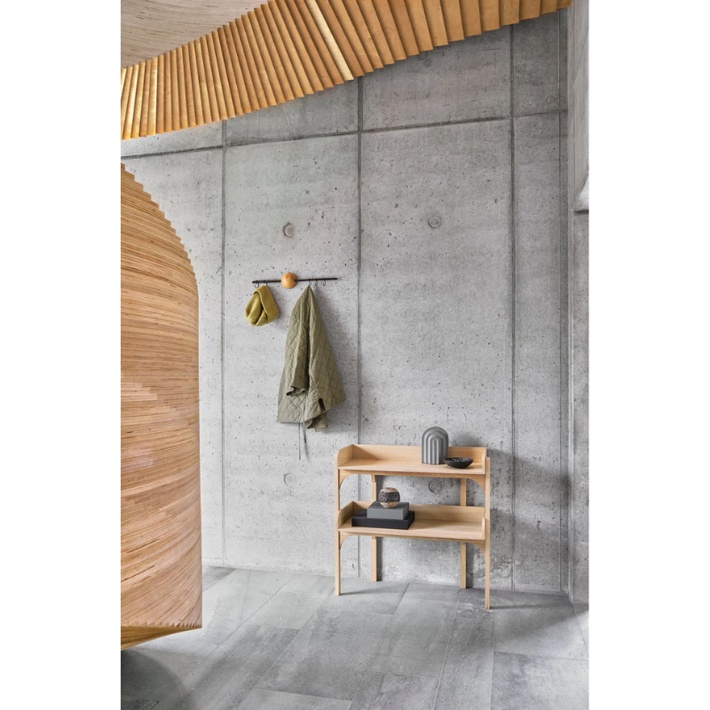 The Utility Shelf from Woud in Oak within a hallway with other Woud products.