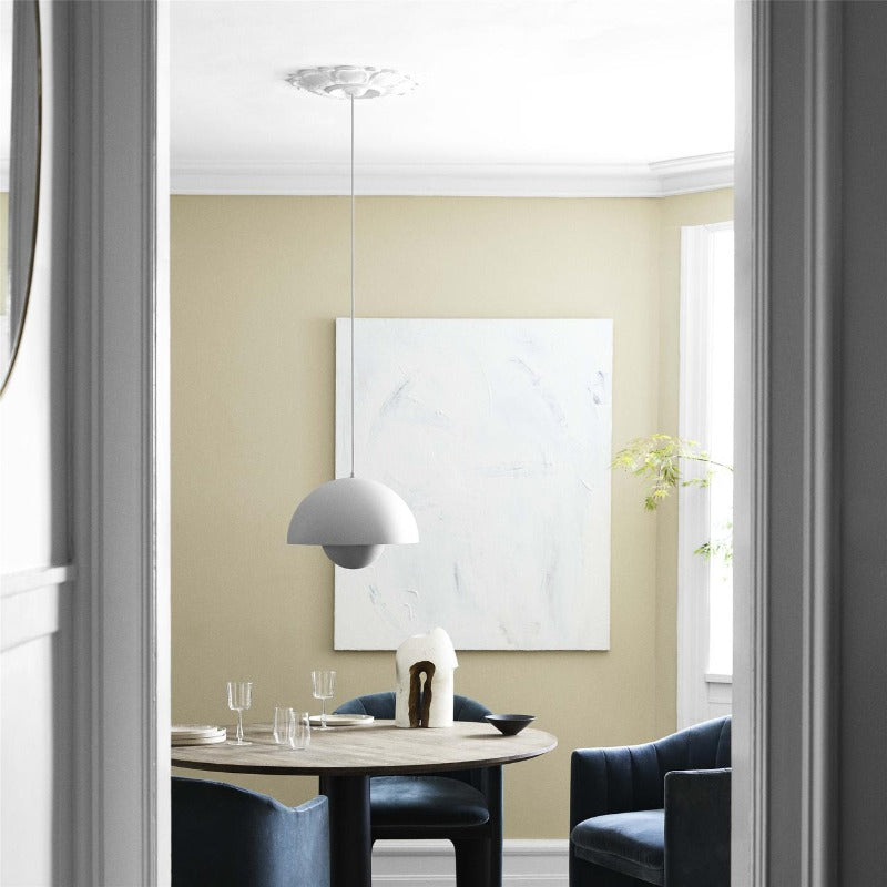 The Matte White Flowerpot VP2 over a dining table.