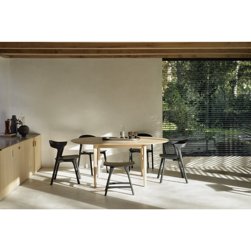 The Round Bok Extendable Dining Table from Ethnicraft within a lounge area.