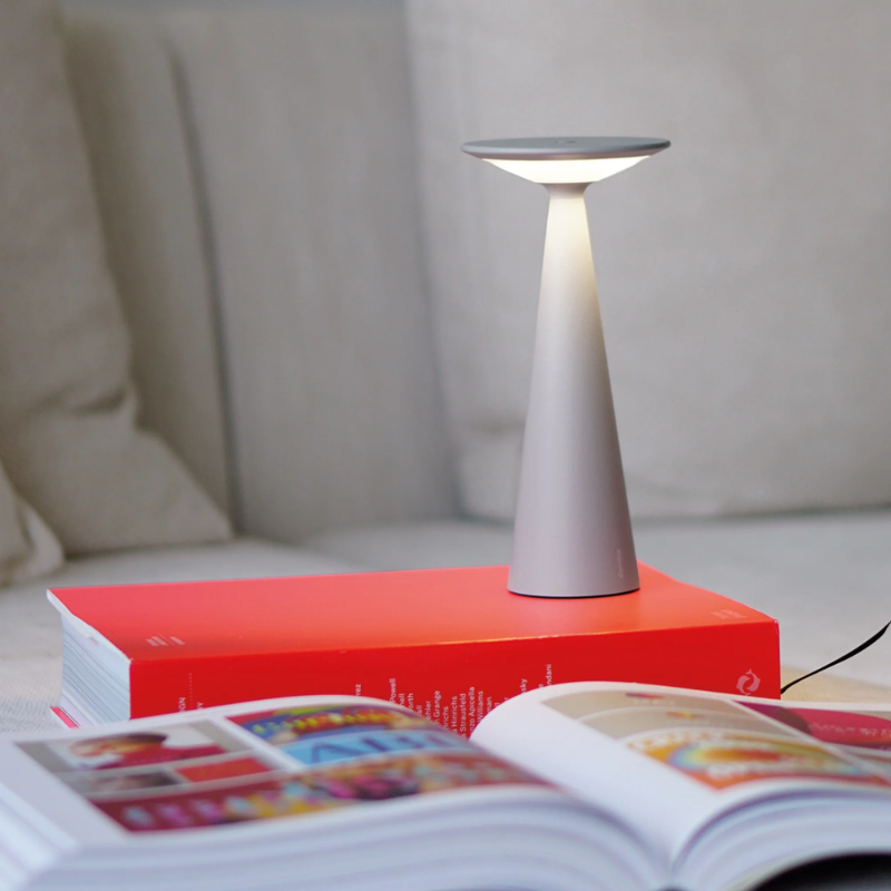 The gray Damina Pro from Zafferano used as a reading lamp.