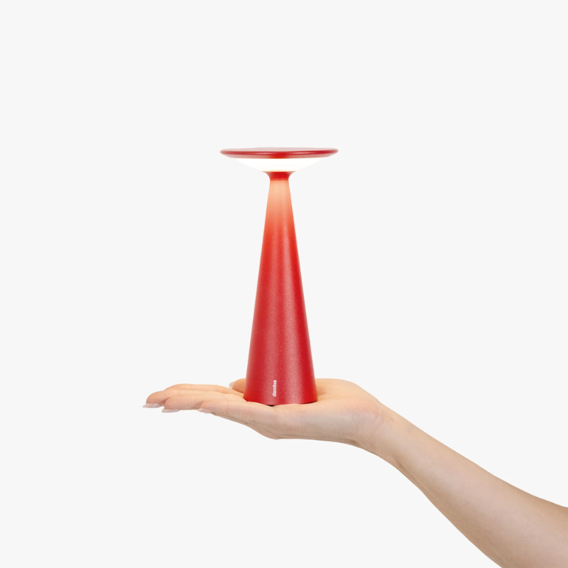 The red Damina Pro from Zafferano, a portable and lightweight light.