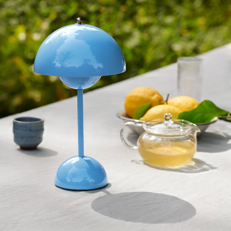 &Tradition VP9 Flowerpot Portable Table Lamp in Swim Blue being used on outdoor dining table.