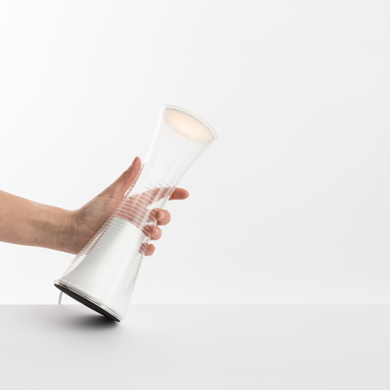 The Come Together Portable Lamp from Artemide in white in a lifestyle.