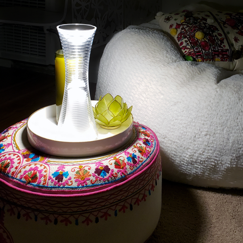 The Come Together Portable Lamp from Artemide in white in a living room.