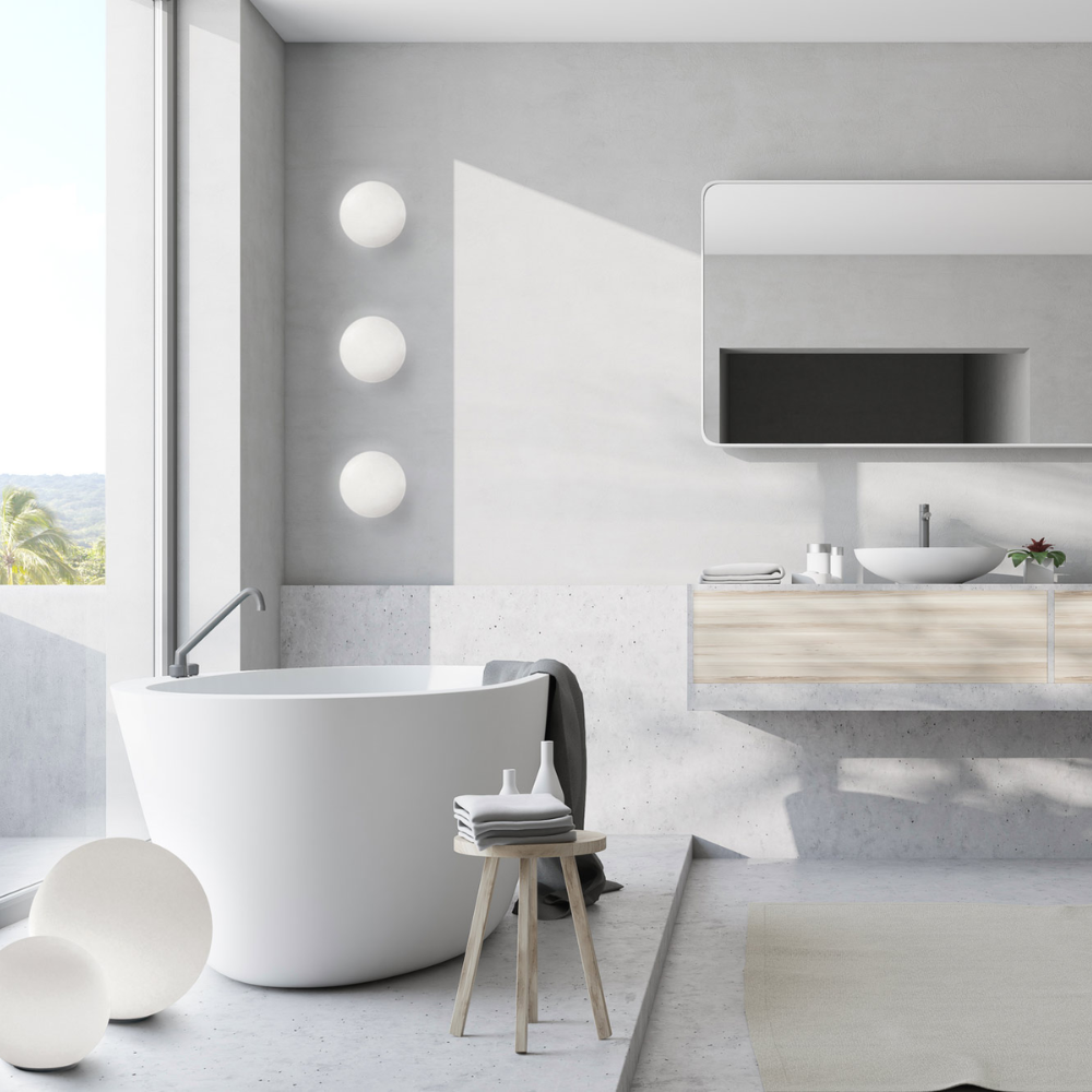 The Dioscuri Wall / Ceiling Light from Artemide in the size medium in a bathroom.
