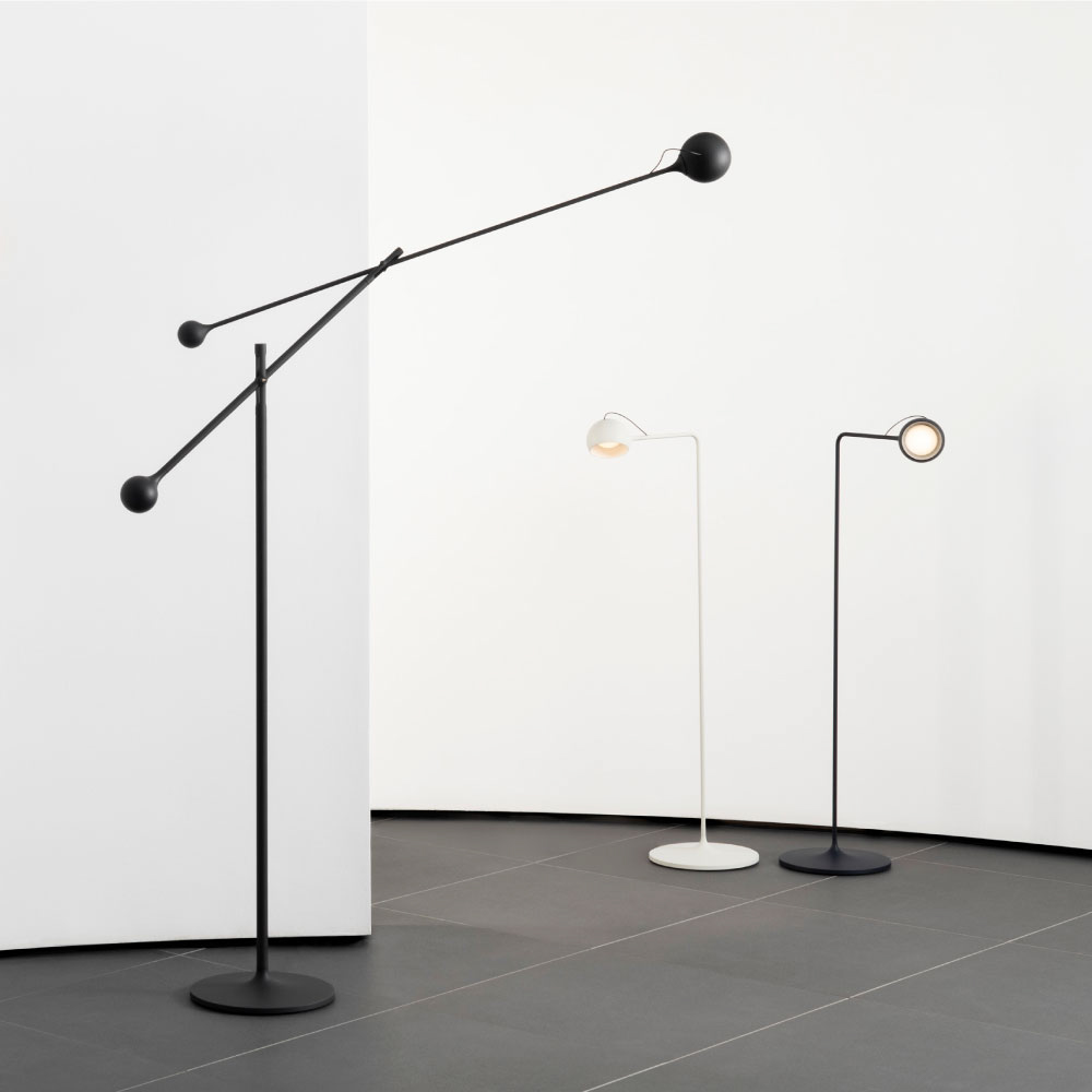 The anthracite gray Ixa Classic Floor Lamp from Artemide in a living room with the Ixa Reading Floor Lamp.