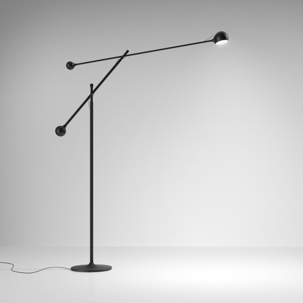 The anthracite gray Ixa Classic Floor Lamp from Artemide in a studio.