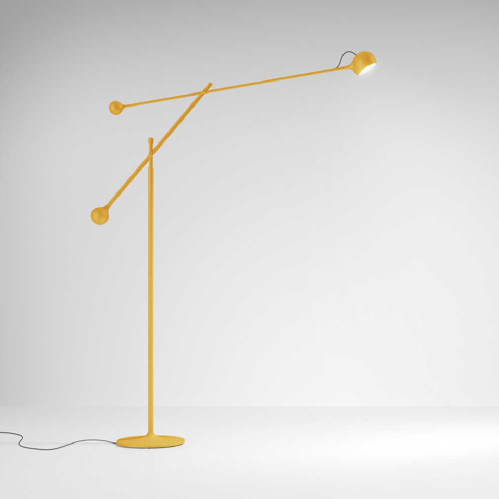 The yellow Ixa Classic Floor Lamp from Artemide in a family space.