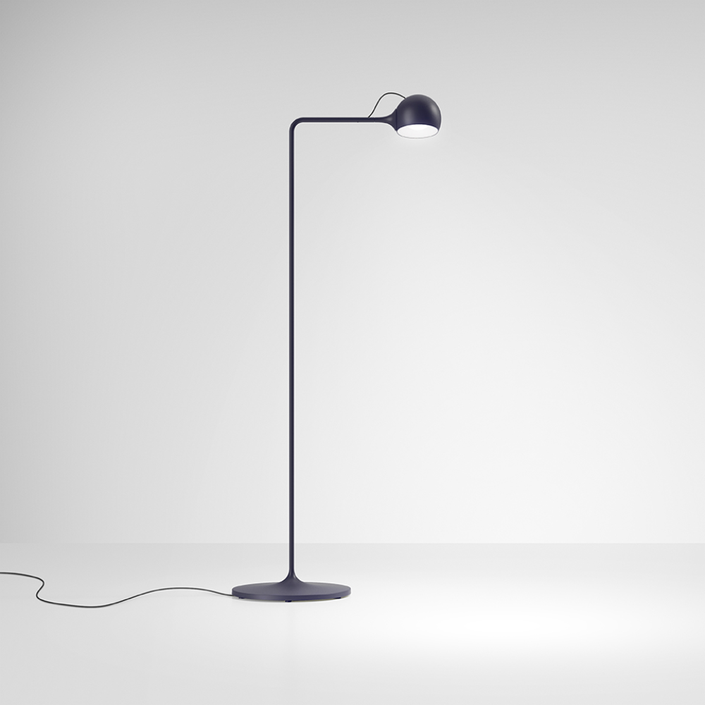 The blue Ixa Reading Floor Lamp from Artemide in a living space.