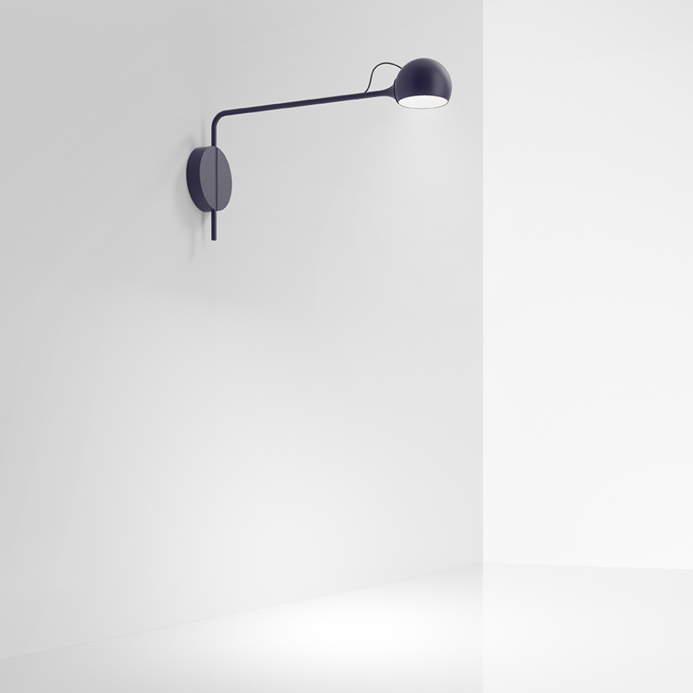 The blue Ixa Reading Wall Sconce from Artemide in a family area.