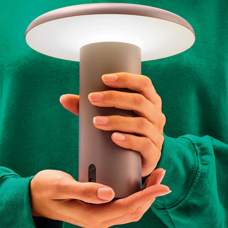 The Takku Portable Lamp from Artemide in gray in real life