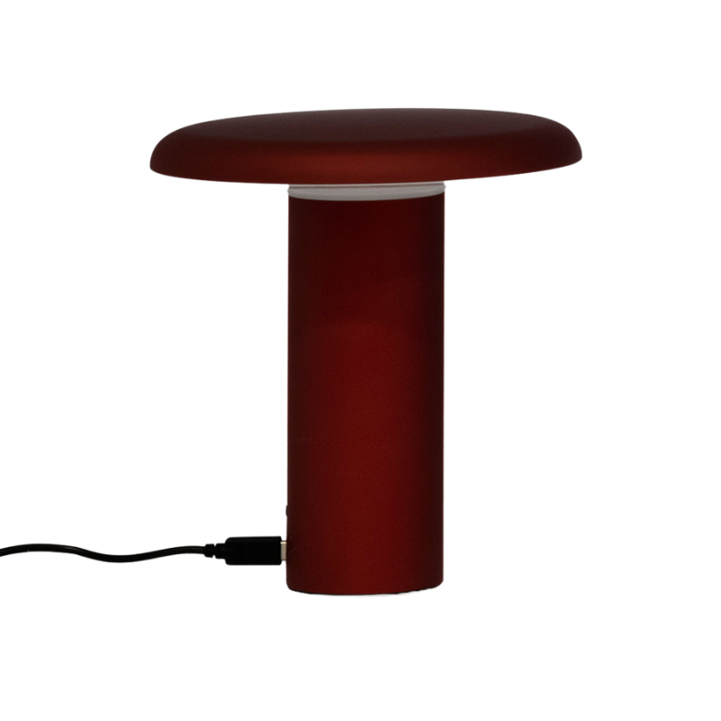The Takku Portable Lamp from Artemide in red.