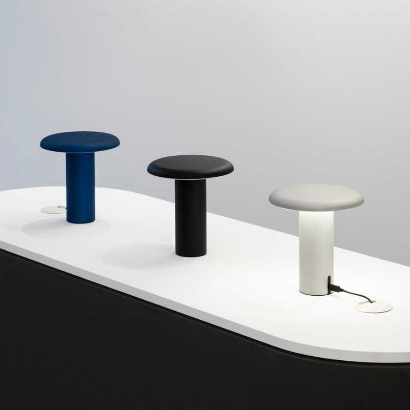 The Takku Portable Lamp from Artemide on a tabletop.