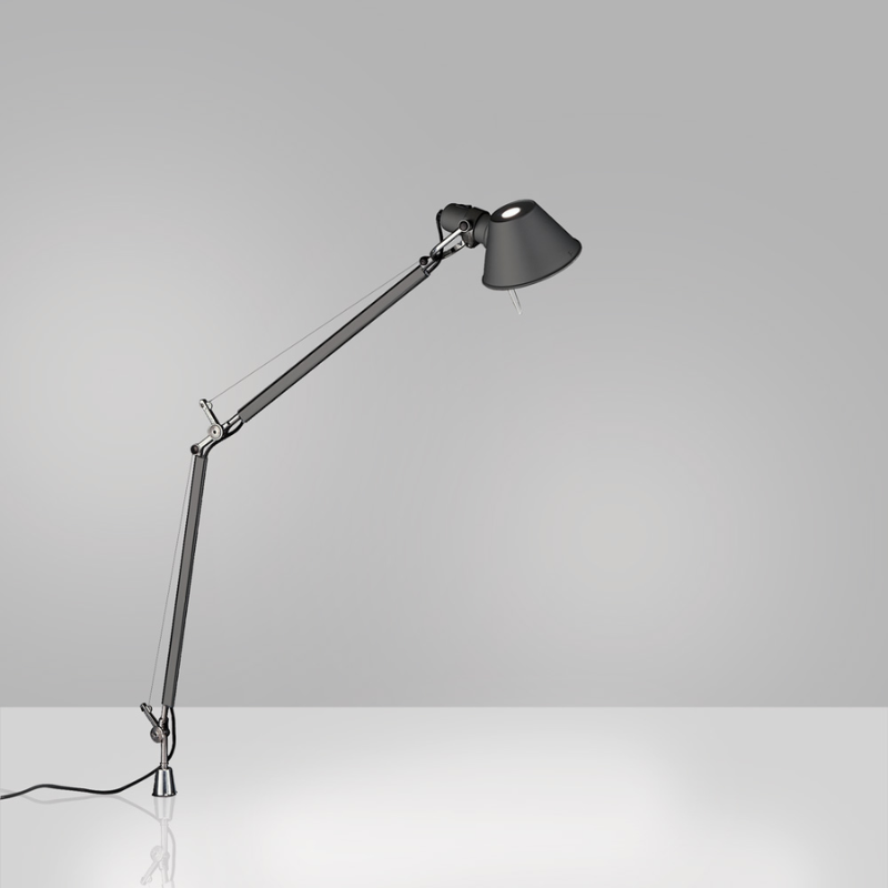 The Tolomeo Midi Table Lamp from Artemide in anthracite grey with the in-set pivot in a lifestyle.