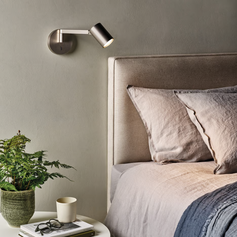 The matte nickel Ascoli Swing Reading Light from Astro Lighting used as a bedside lamp.