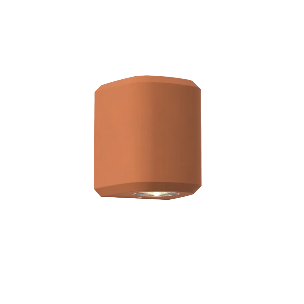 The Brixham Wall Single outdoor sconce in terracotta concrete by Astro Lighting at an angle.