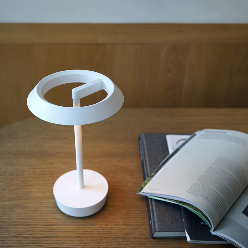 The Halo Portable Lamp from Astro Lighting in matt white in a study room.