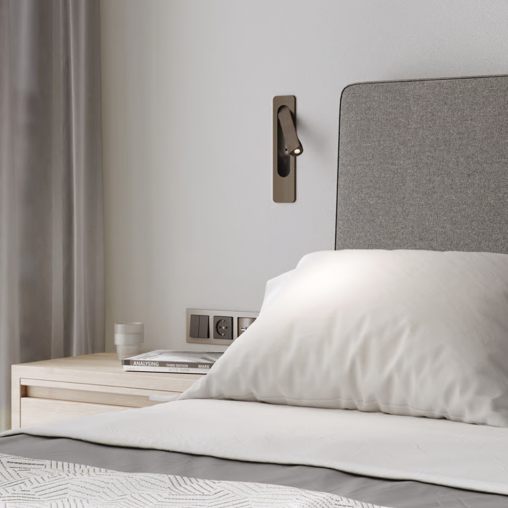 The bronze Keta Reading Light from Astro Lighting in a bedroom.