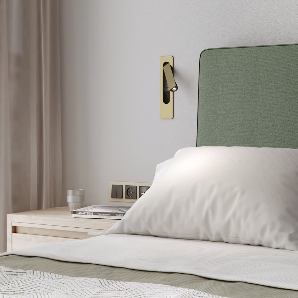The matte gold Keta Reading Light from Astro Lighting in a guest bedroom.