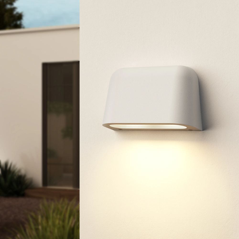 The Mast Twin Coastal Outdoor Wall Sconce by Astro Lighting in white concrete installed outside during the day.