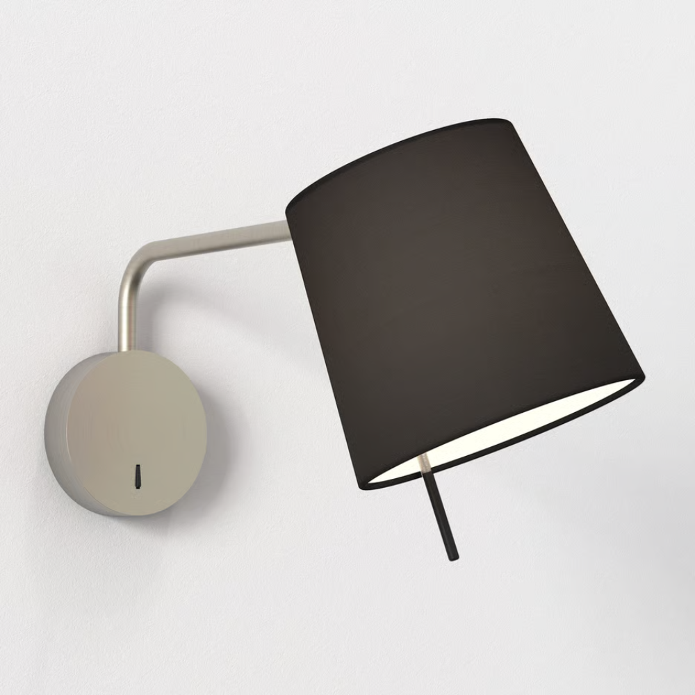 The matte nickel Mitsu Swing Arm Wall Sconce from Astro Lighting with the black shade in a hospitality space.