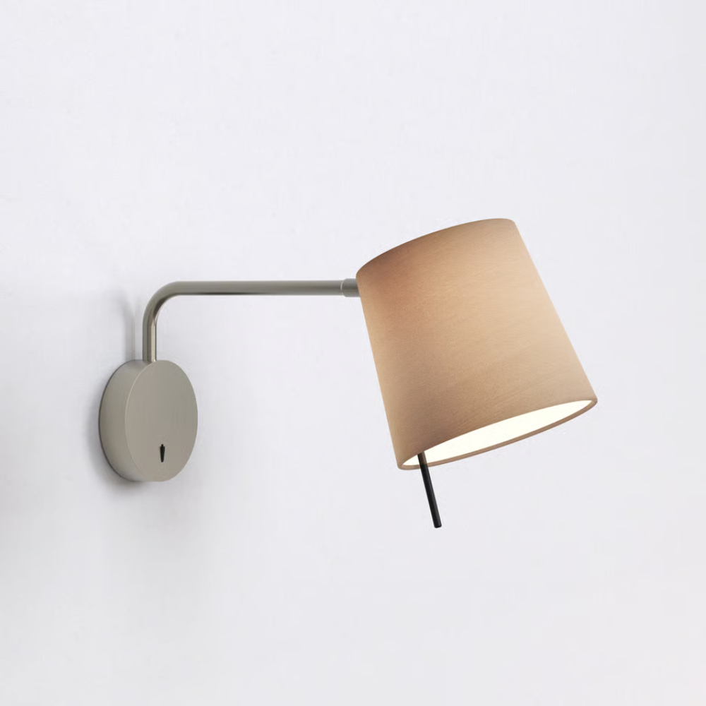 The matte nickel Mitsu Swing Arm Wall Sconce from Astro Lighting with the oyster shade in a business building.