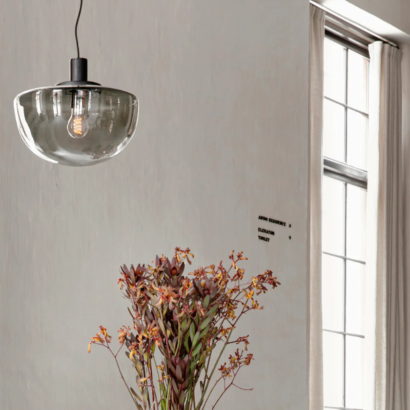 The Bank Pendant from Audo Copenhagen in a living room.