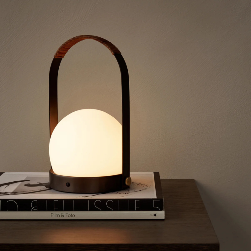 The Carrie Portable LED Lamp from Audo Copenhagen in a bedroom.