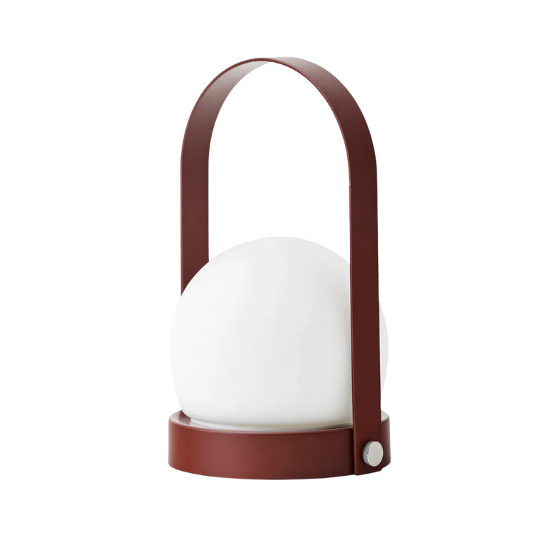 The Carrie Portable LED Lamp from Audo Copenhagen in burned red.