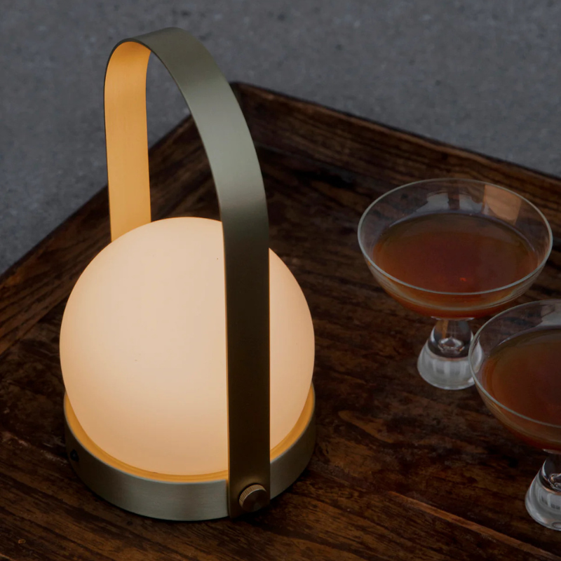 The Carrie Portable LED Lamp from Audo Copenhagen in a dining room.