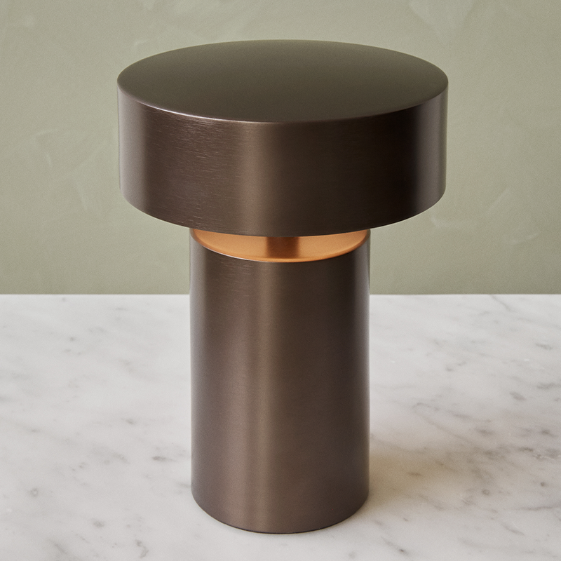 The Column Portable Table Lamp from Audo Copenhagen in anodized aluminum in a lounge.