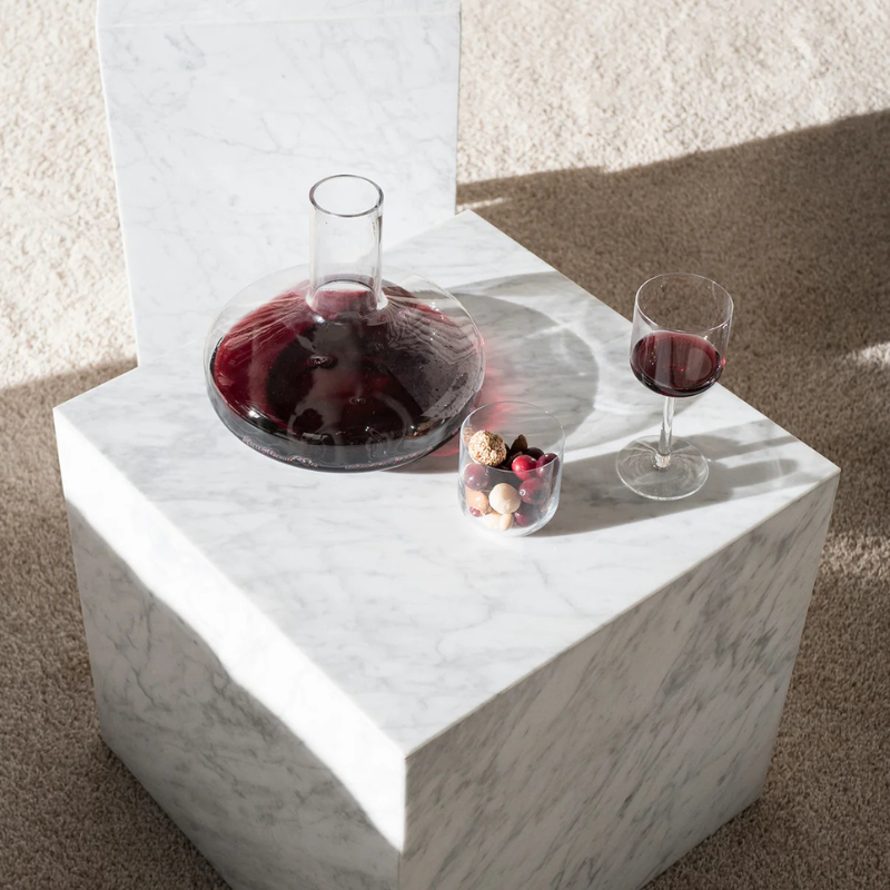The Cubic Marble Plinth from Audo Copenhagen in a kitchen and dining setting.