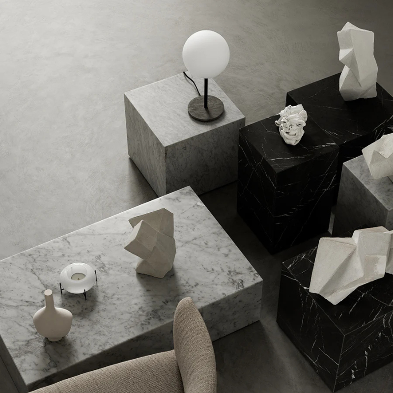 The Cubic Marble Plinth from Audo Copenhagen in a living room.