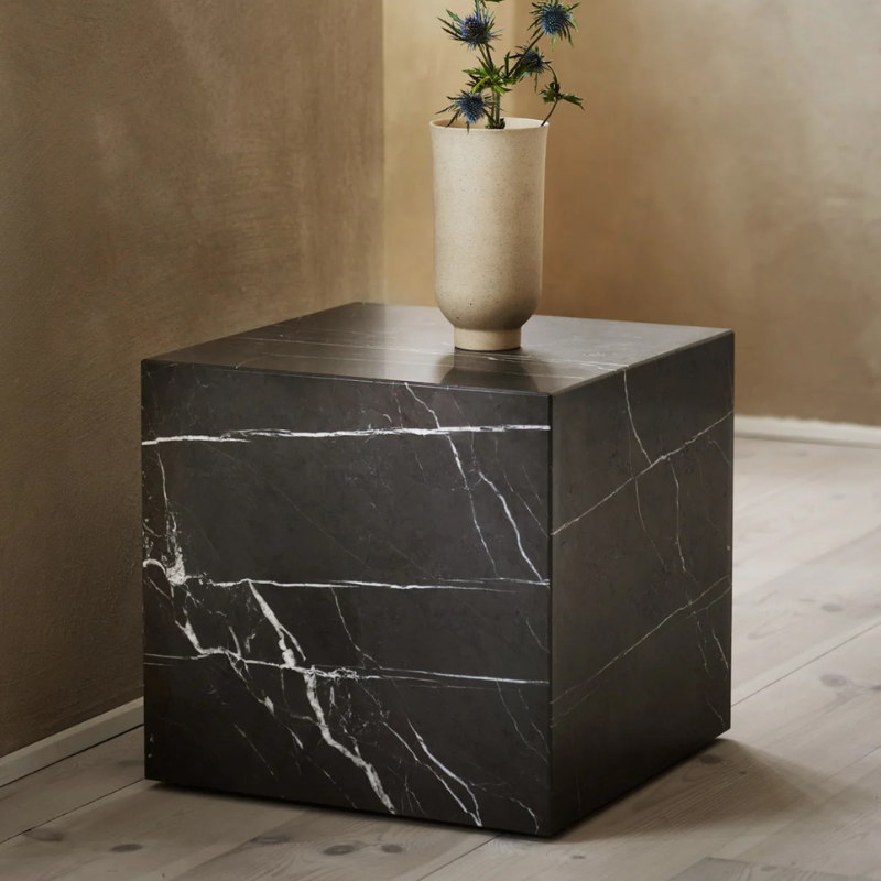 The Cubic Marble Plinth from Audo Copenhagen used as a side table.
