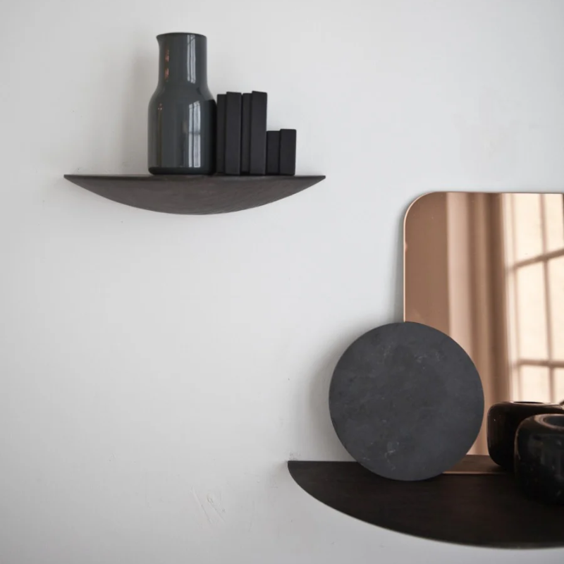 The Gridy Fungi Shelf from Audo Copenhagen in black oak in a large size on the wall of the dining room.