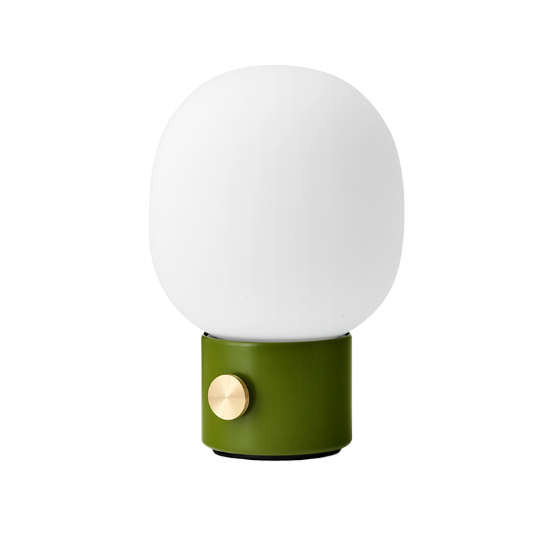 The JWDA Portable Table Lamp from Audo Copenhagen in dusty green from the side.