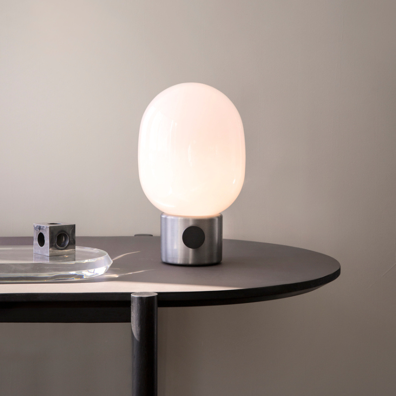 The JWDA Table Lamp from Audo Copenhagen on a dining table.