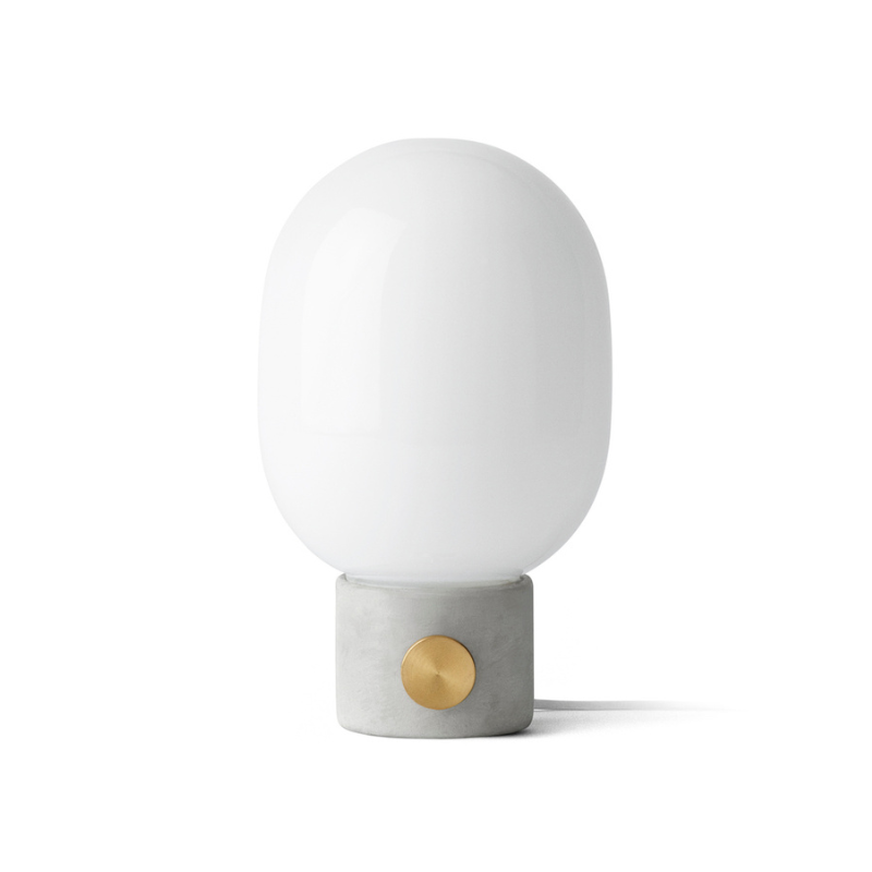 The JWDA Table Lamp from Audo Copenhagen in light grey concrete.