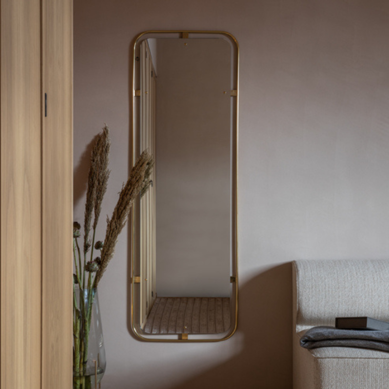 The Rectangular Nimbus Mirror from Audo Copenhagen in a bedroom.