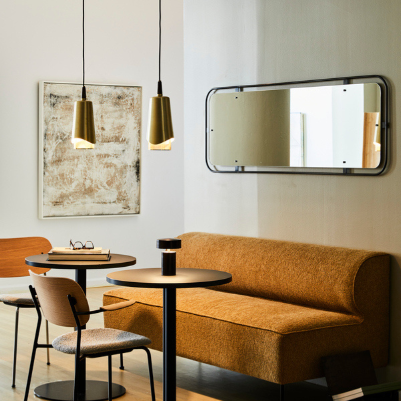 The Rectangular Nimbus Mirror from Audo Copenhagen in a dining room.