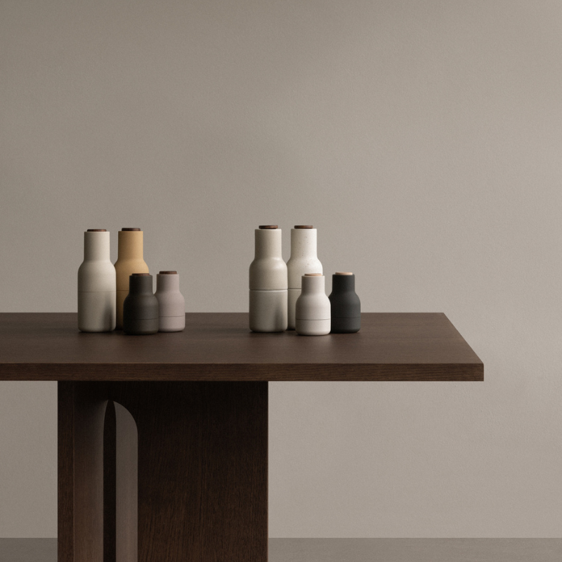 The Small Bottle Grinder from Audo Copenhagen in a dining room.