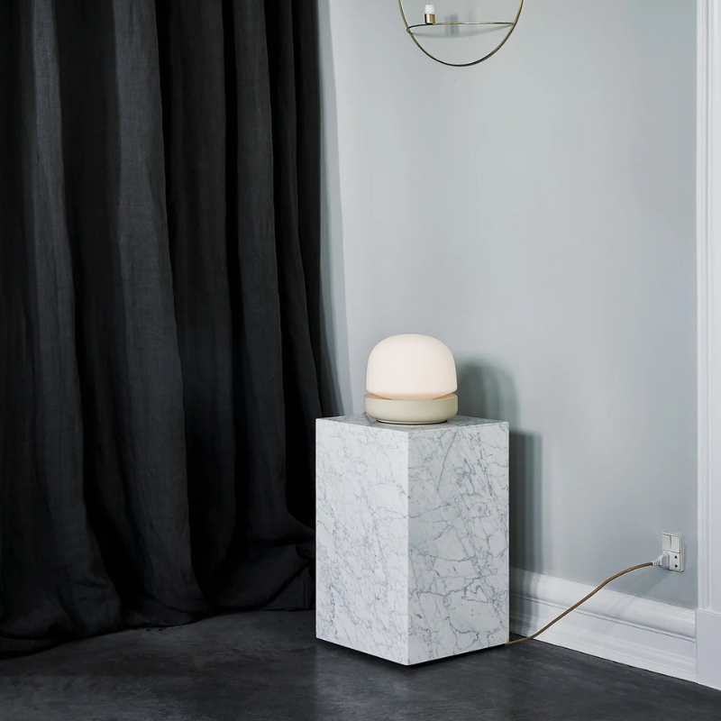 The Tall Marble Plinth from Audo Copenhagen in a lounge.