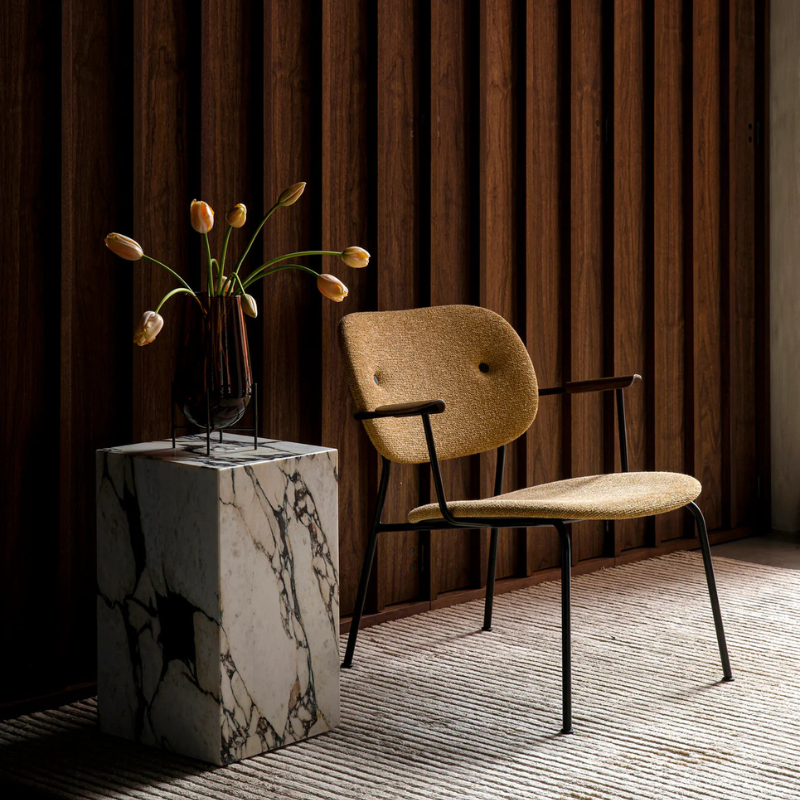 The Tall Marble Plinth from Audo Copenhagen used as a side table.